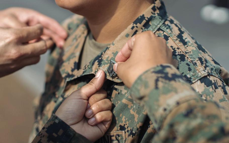 U.S. Marine Corps Sgt. Amelia Kang, a combat graphics specialist assigned to the 15th Marine Expeditionary Unit, and a native of Portland, Oregon, is promoted to sergeant aboard the amphibious assault ship USS Boxer (LHD 4) at Busan Naval Base, South Korea, Sept. 8, 2024. The 15th MEU was in South Korea conducting Exercise Ssang Yong 24 to strengthen the Republic of Korea-U.S. Alliance through bilateral, joint training, contributing toward combined amphibious capability in defense of the Korean Peninsula. 