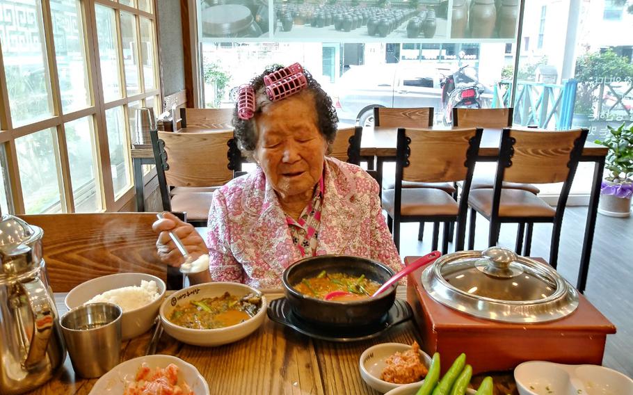 My grandmother enjoys a gukbap (soup) after bathing.