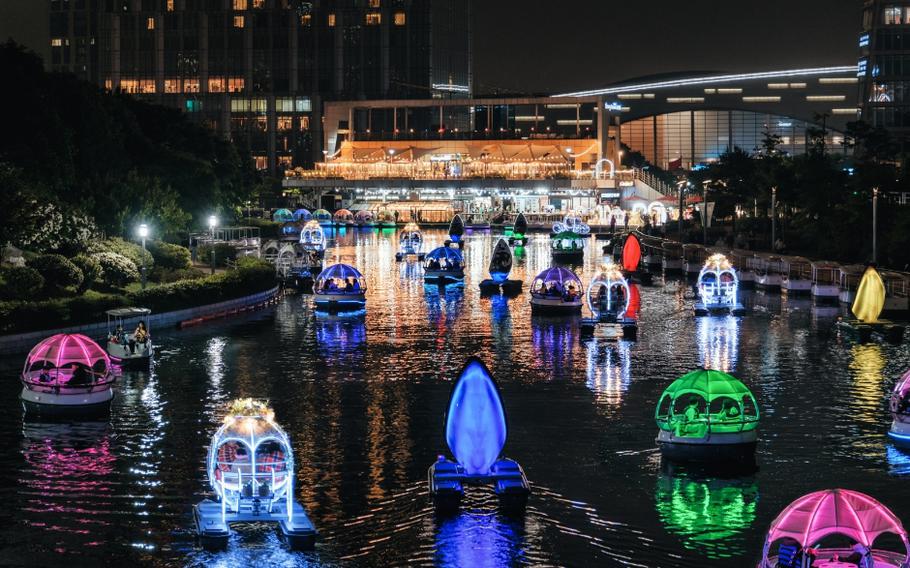 Illuminated boats can be seen on the pond at Songdo Central Park.