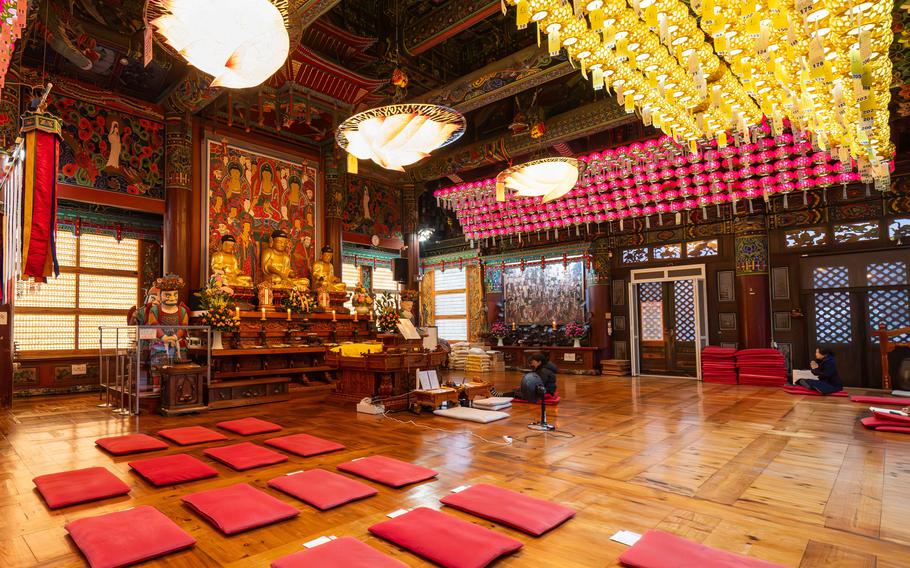 The interior of the temple. Some square floor cushions for kneeling on are on the floor.