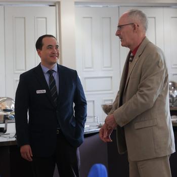 Sean Wise, on the left, USAG Daegu Director of Family, Morale, Welfare and Recreation, and a 2024 IMCOM Stalwart Award winner, in discussion with a customer at a recent event. 