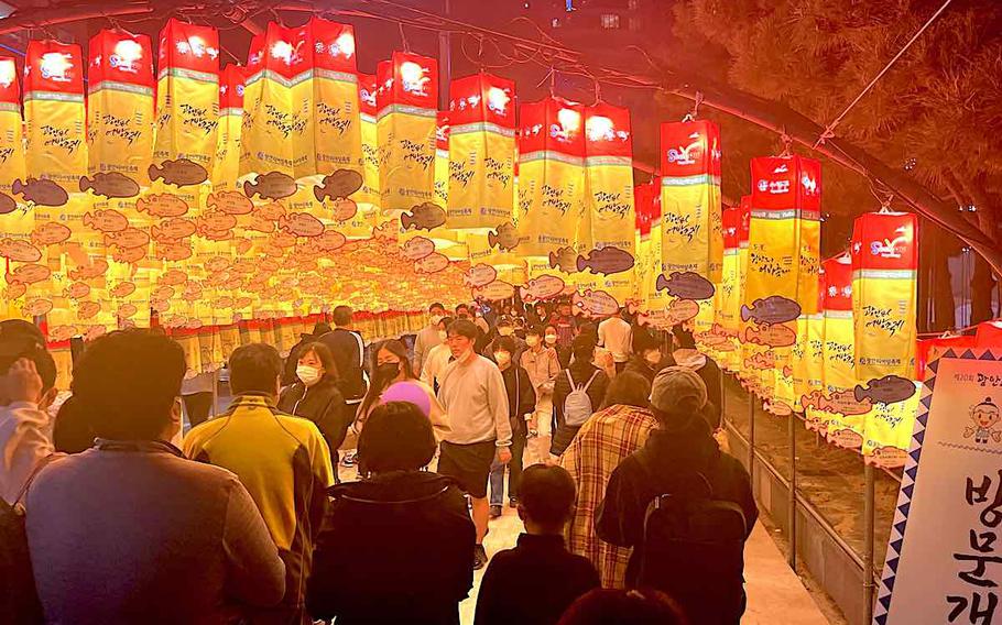 people enjoying a festival. many lanterns can be seen.