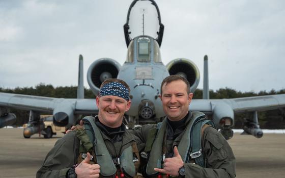 U.S. Air Force Capt. Jacob Stafford, 25th Fighter Squadron A-10C Thunderbolt II pilot, left, and Lt. Col. Justin Ledvina, 25th FS director of operations, pose for a photo during the Ninja Mustang training event at Misawa Air Base, Japan, March 7, 2024. Ninja Mustang is a training event within the Ninja Draggin series, where 51st FW Airmen relocate to collaborate with units across the Pacific. This initiative enhances the lethality and coordination of units within the pacific theater. During the training event, the two aircraft from the 25th Fighter Squadron successfully relocated to a different portion of the pacific area of responsibility, and to effectively delivered 12,000 lbs of simulated munitions to their targets.