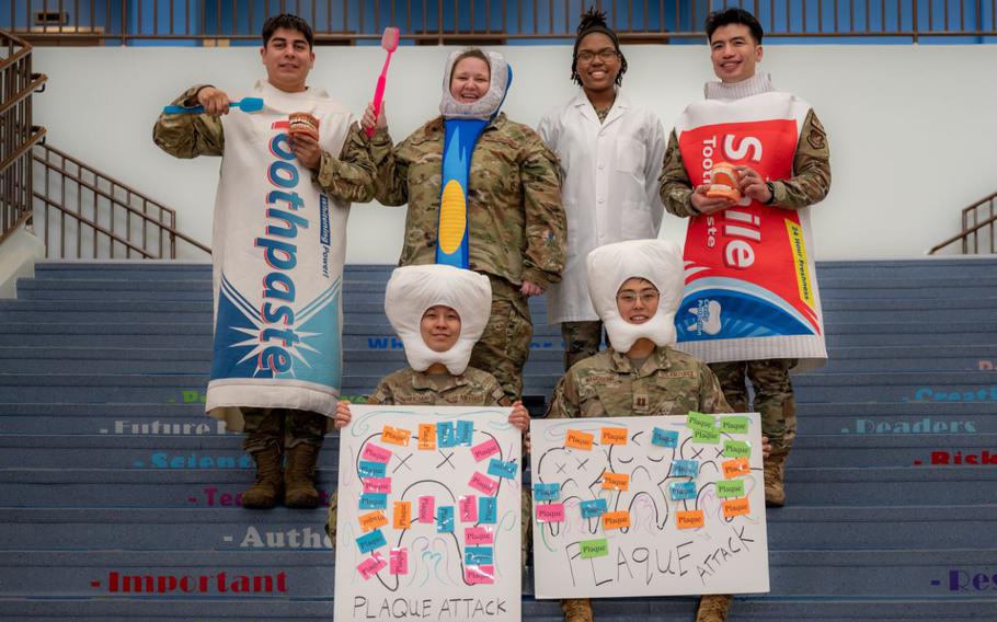 U.S. Airmen assigned to the 51st Medical Group dental clinic pose for a photo at Osan Air Base, Republic of Korea, Feb. 23, 2024. The Airmen visited Osan Elementary School for National Children’s Dental Health Month. Their goal was to spread awareness about the importance of dental hygiene to children.