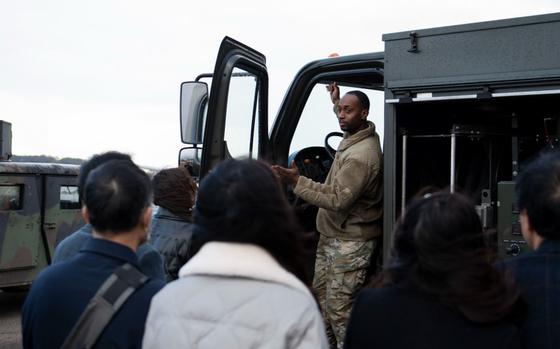 U.S. Air Force Staff Sgt. Dandre McCoy, 51st Logistics Readiness Squadron fuel distribution supervisor, explains the function of an R-11 Refueler during the Osan-Songtan Community Advisory Council tour at Osan Air Base, Republic of Korea, Nov. 26, 2024. This tour introduced members of the local community to different units and members stationed on base. The OSCAC began in 2004 and allows members of the base and local community to work together to resolve issues. 