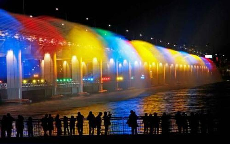 People enjoy the Banpo Bridge Rainbow Fountain.