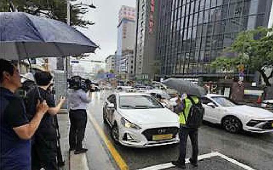 A man is shooting a taxi.