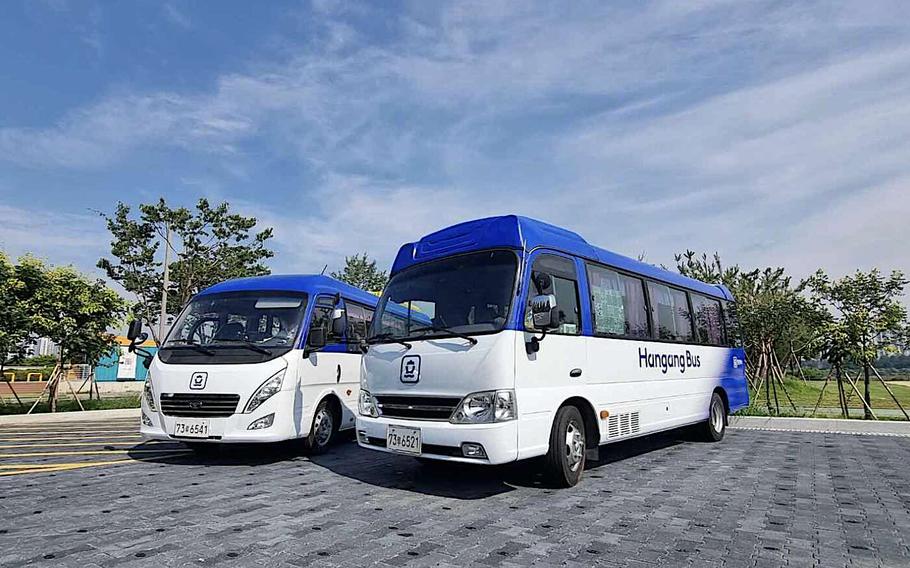 Two buses are parked in the parking lot.