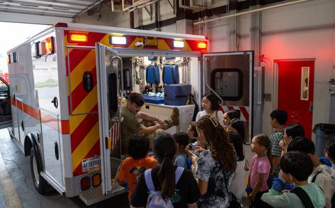 Photo Of Senior Airman Robert Roy, 51st Civil Engineer Squadron driver operator, answers questions about emergency services.