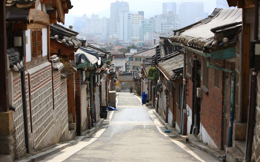 The street is lined with traditional houses on each side.