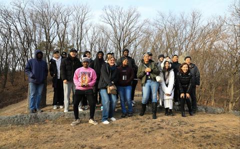 Photo Of A group of 21 U.S. Soldiers, KATUSAs, and civilians assigned to U.S. Army Garrison Yongsan-Casey and 210th Field Artillery Brigade take a commemorative photo at General Eo, Yu-so’s tomb on Camp Hovey.