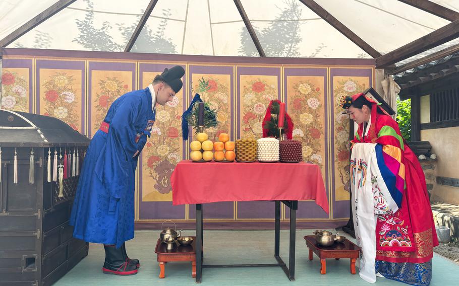 Two people bow.