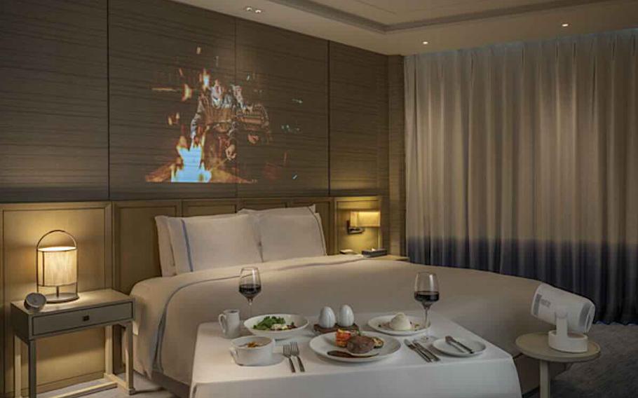 A dinner is set on the table in the hotel room.