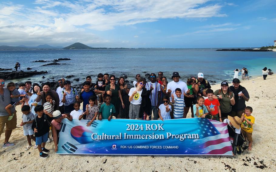 participants pose on the beach.