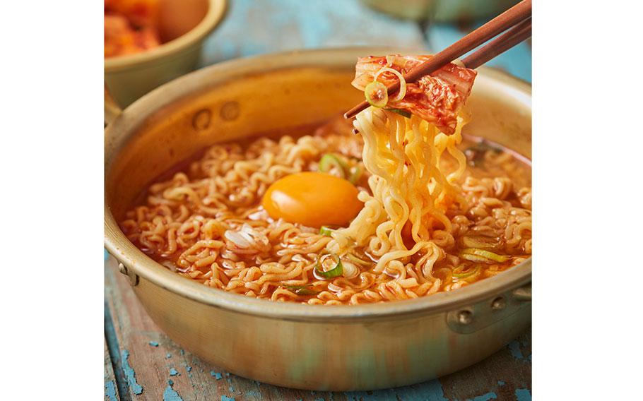 korean noodles with an egg in a pot.