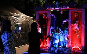 A visitor takes a photo at Lumina Horror Night.