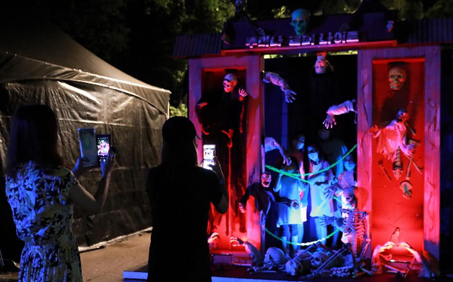 A visitor takes a photo at Lumina Horror Night.