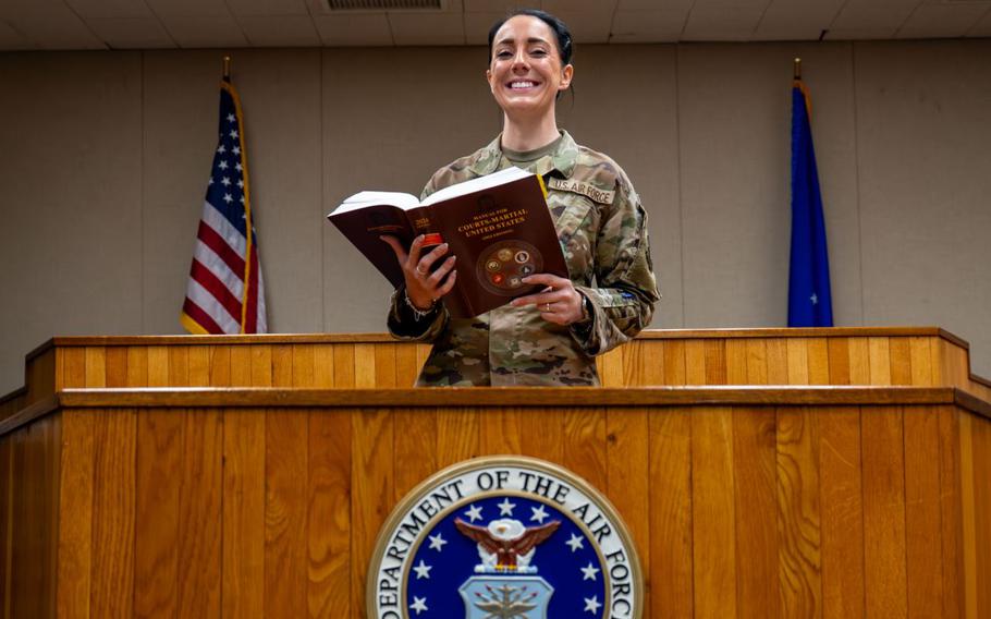 Tech. Sgt. Lacey Eakin poses for a photo with smile in the courtroom at Kunsan Air Base.