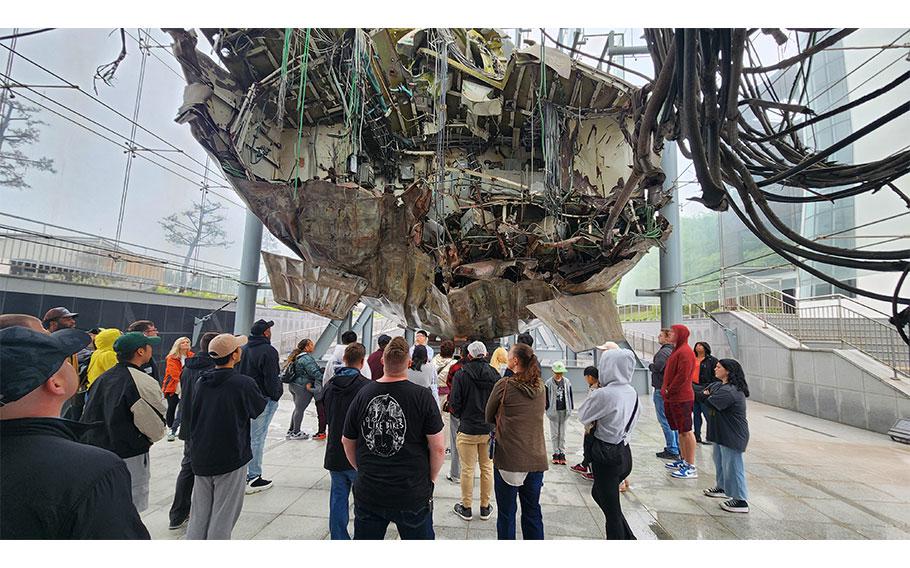 U.S. military community members view the remains of Cheonan, a ship split in half after an attack by North Korea in 2010.