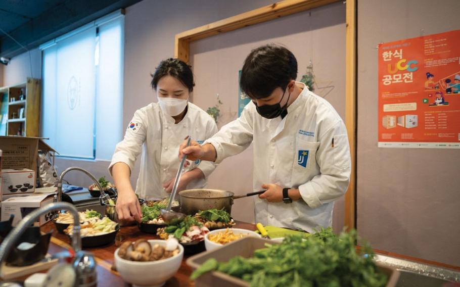 Two chefs are cooking bibimbap.