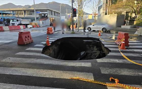A sinkhole in the road.
