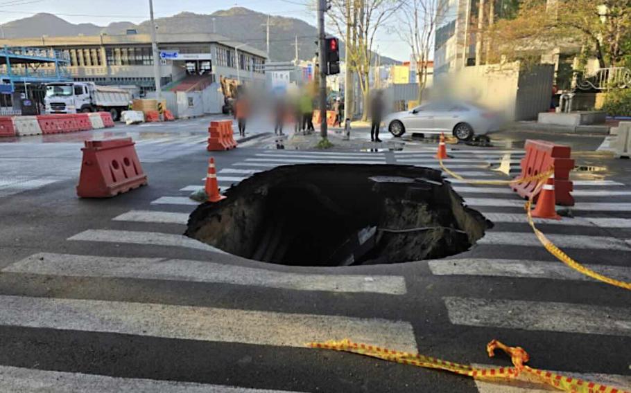 A sinkhole in the road.
