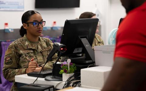 Photo Of Airman Janai Gardner reviews a customer’s shipping information.
