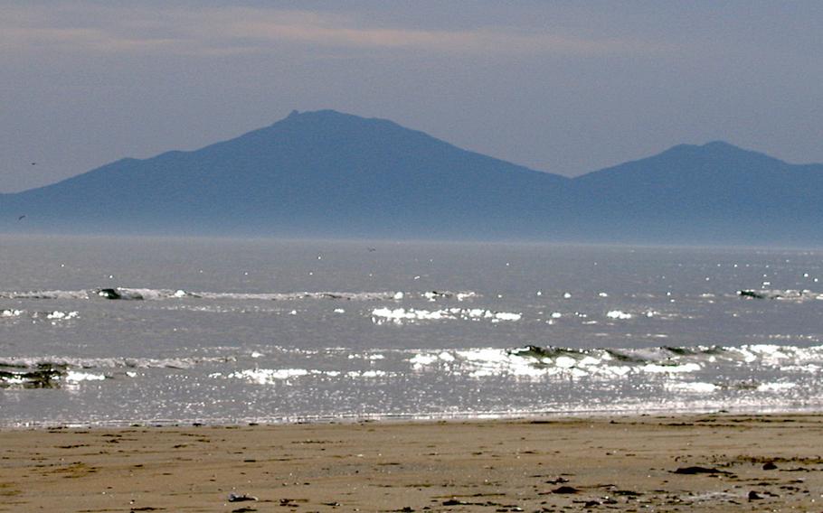 Mountains can be seen from the beach.