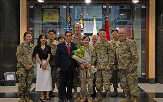 Photo Of Yi, Chong Cha (center), poses for a photo with members if the Eighth Army Safety Directorate and Korean Service Corps Safety Office following her retirement ceremony at Eighth Army headquarters on Camp Humphreys, South Korea, Aug. 29, 2024.