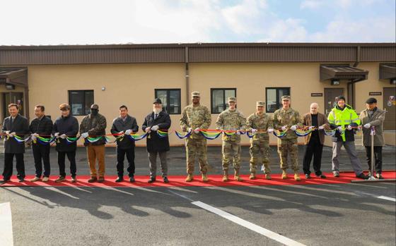 Soldiers and civilian workers pose for a photo to celebrate the opening of the new transportation motor pool (TMP) office at Camp Casey on Jan. 7.