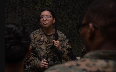 Photo Of U.S. Navy Lt. Lillian Jentz listens to instructions on radio system operation.