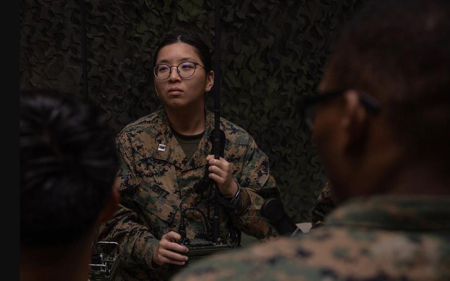 U.S. Navy Lt. Lillian Jentz listens to instructions on radio system operation.