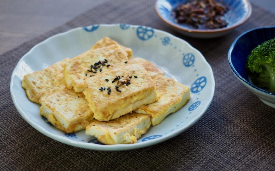 Bean curd topped with black sesame on the table.