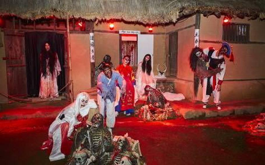 Staff members wear costumes of ghosts.