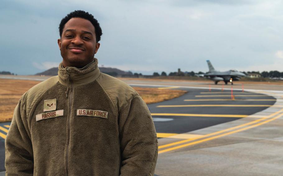 Senior Airman Nigel Harris is smiling o the flightline.