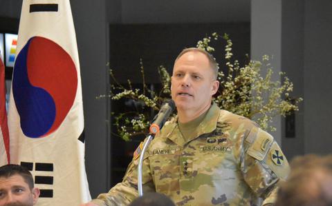 Photo Of Lt. Gen. Christopher C. LaNeve is making a speech. A South Korean national flag can be seen beside him,