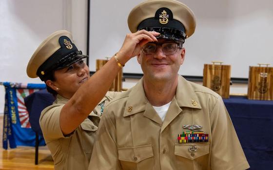 Photo Of U.S. Navy Chief Mass Communication Specialist Claire Farin places a chief petty officer cover on U.S. Navy Chief Information Systems Technician (Network) Brian Espetitee, assigned to Unmanned Undersea Vehicle Squadron 3, during a chief petty officer pinning ceremony held at Fleet Activities Yokosuka, Sept. 27, 2024. The rank of chief petty officer is seen as a significant milestone in an enlisted Sailor’s career. With the advancement comes an increased responsibility of taking charge and training Sailors.