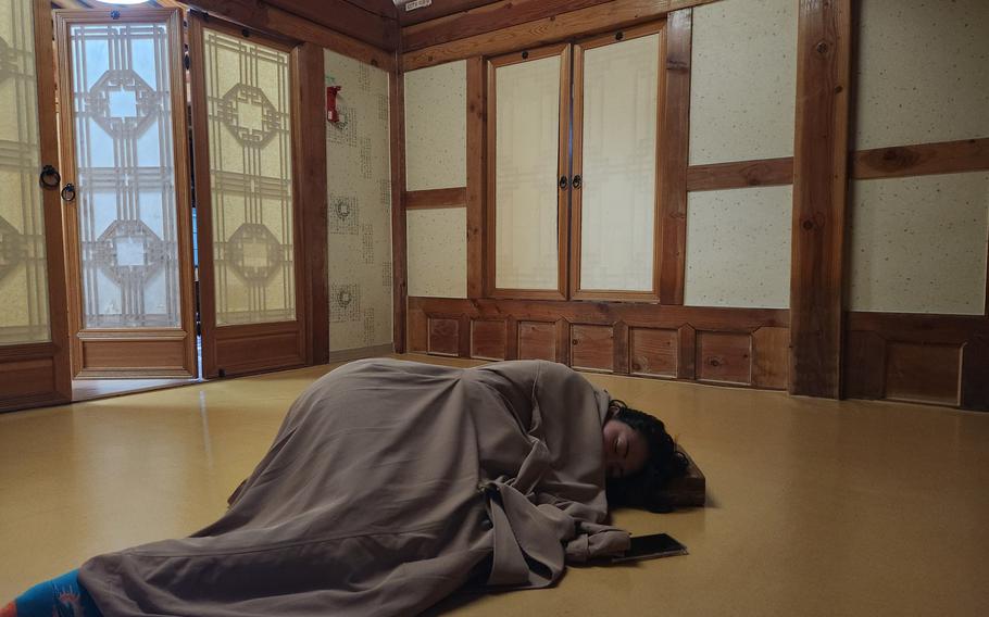 a person in a blanket taking a nap in the sleeping room.