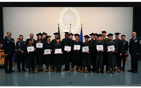 Photo Of Master’s degree recipients pose with base leadership during the Joint Force Graduation ceremony at Kunsan Air Base.