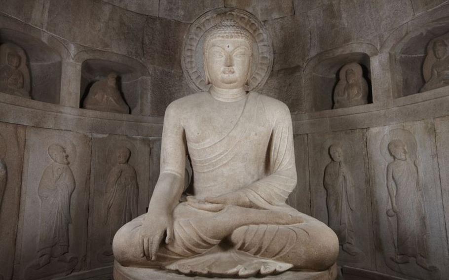 Seated Buddha surrounded by the wall.