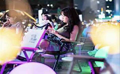 Photo Of Visitors are enjoying reading books outside.