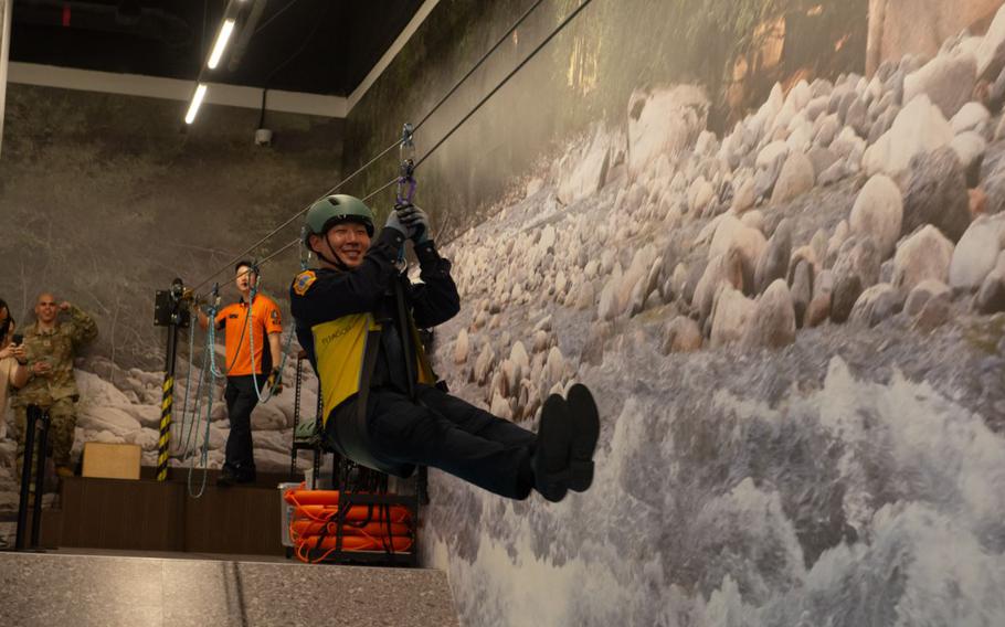 Juhyuk Baek, 51st Civil Engineer Squadron fire inspector, crosses a simulated flooded river.