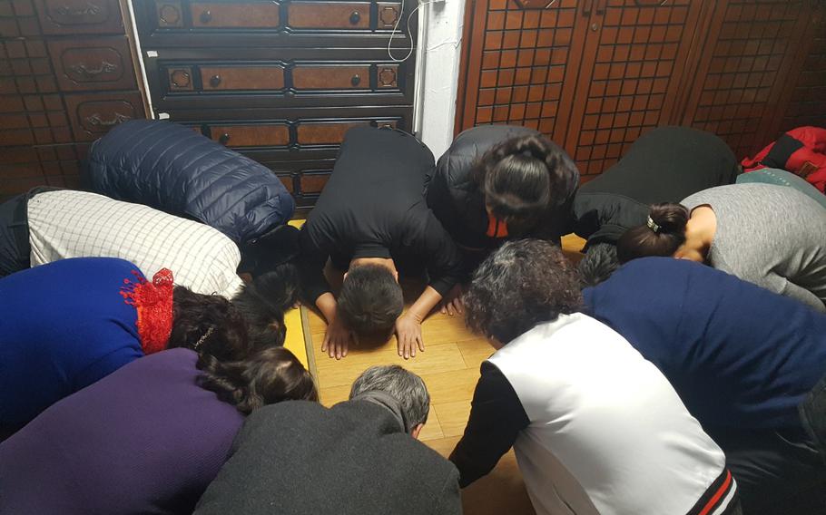 My aunts and uncles bow to each other to wish good fortune in the new year for Sebae.