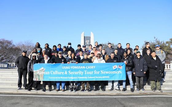 Photo Of A group of U.S. Soldiers stationed at Camp Casey poses in front of the Mangbaeden Memorial Park during a DMZ tour in Paju, South Korea, Jan. 23, 2025.