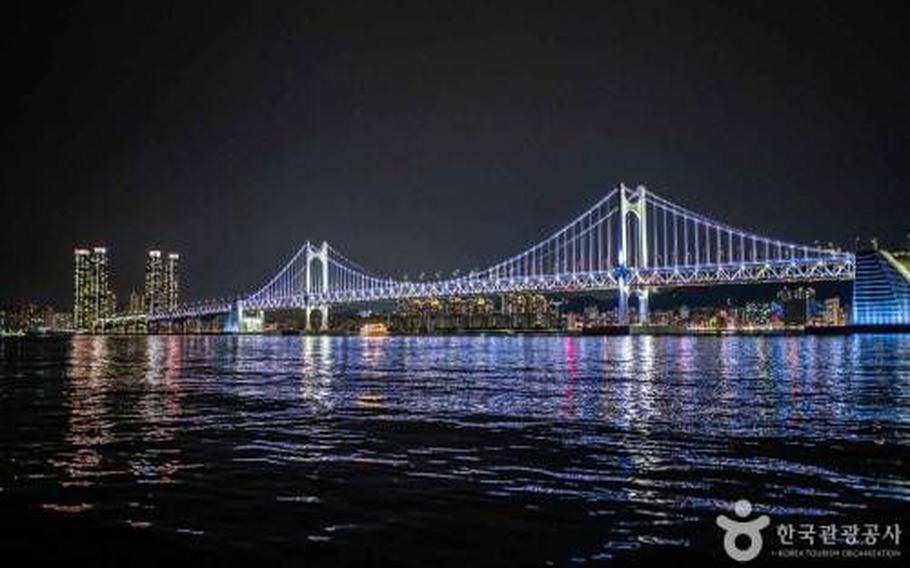 Gwangalli Beach at night. A bridge is lit up.