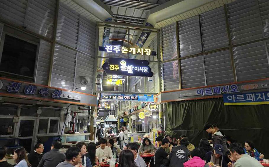 People enjoy their meal at the night market.