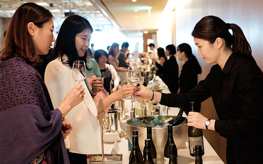 Visitors enjoys the tasteing of wine.