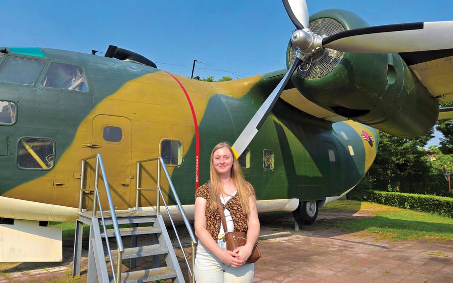 Senior Airman Jordan poses for a photo in front of a fighter plane.