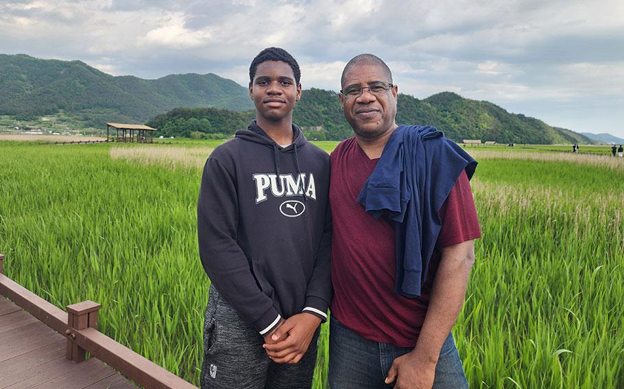A peaceful father-son moment while strolling in the Suncheonman Wetland Reserve.