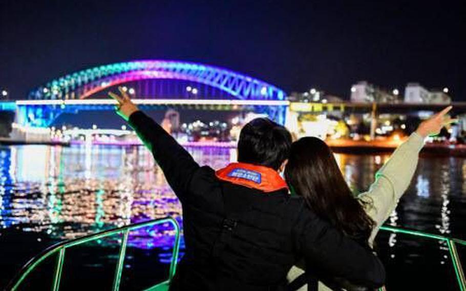 A couple facing the back pose for a photo during the tour.